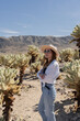 © Julija - woman visiting Joshua Tree National park, enjoy Cholla cactus garden.
