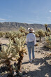 © Julija - woman visiting Joshua Tree National park, enjoy Cholla cactus garden.