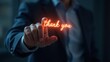 © Oxana39 - Interactive thank you gesture with glowing text in business attire