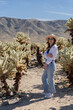 © Julija - woman visiting Joshua Tree National park, enjoy Cholla cactus garden.