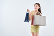 © PHOTOGRAPHER JH - A beautiful Asian woman wearing a green one-piece dress and holding shopping bags in both hands in various poses.