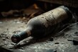 © Thanapong - A dusty old wine bottle lying on its side in a dark, forgotten cellar, surrounded by cobwebs and broken glass. Ample copy space to evoke the passage of time and lost treasures.