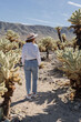 © Julija - woman visiting Joshua Tree National park, enjoy Cholla cactus garden.