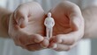 © JP STUDIO LAB - Hands gently enclosing small figurines depicting security responsibility and human-centric approach in modern organizations