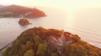 Wall Mural - Sunset view over the statue of Christ in San Sebastian town, Basque country, Spain 