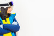 © Evaldas - Skier young woman wearing warm padded windbreaker jacket hat ski goggles mask point index finger aside on copy space blank area travel rest spend weekend winter season. Isolated on white background