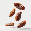 © yailek - Floating dates on a white isolated background, highlighting their rich texture and natural sweetness.