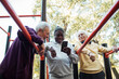 © Marko Geber - Senior men socializing and relaxing at outdoor park fitness area