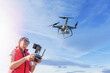 © Denis Rozhnovsky - A young woman controls a drone with a remote control in her hands.