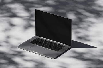 Wall Mural - Scene with an open laptop with a blank screen on a concrete background