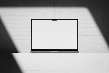 Wall Mural - scene with an open laptop with a blank white screen on a concrete background