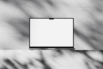 Wall Mural - scene with an open laptop with a blank white screen on a concrete background