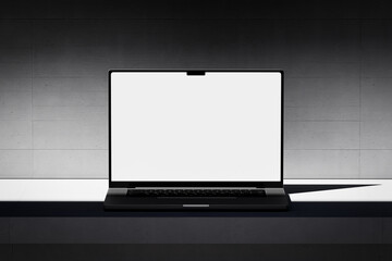 Wall Mural - scene with an open laptop with a blank white screen on a concrete background