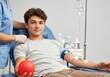 © Anna - Young man donating blood in clinic with nurse support