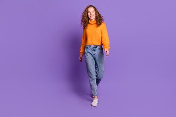 Wall Mural - Full size photo of nice young girl walk empty space wear pullover isolated on violet color background