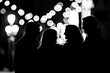 © Michael - Black Silhouette of a group of friends chatting and laughing on a street corner at night on a white background.