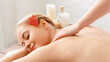 © Prostock-studio - Thai body massage. Enjoying massage smiling girl pleasure to procedures, with spa accessories
