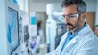 © Evgenii - A focused scientist in a white lab coat examines data on a computer screen in a well-equipped laboratory
