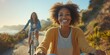©  Serhii Hryb - Two Friends Ride Bicycles Along a Scenic Coastal Path on a Sunny Day, Enjoying Laughter and Fresh Air While Surrounded by Beautiful Nature