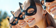 © IndigoElf - Group of smiling teenage girls wearing cat masks against sunny park background. Trends, quadrobics subculture