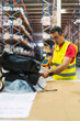 © Koldo_Studio - Warehouse worker scanning package with barcode scanner