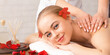 © Prostock-studio - Aroma procedures concept. Smiling girl on table with petals has massage