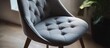 © NFTNexus - Grey chair pad featuring elegant buttoned details ideal for enhancing comfort and design in home decor