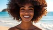 © bvbflo1 - A woman with an afro smiling at the camera on a beach