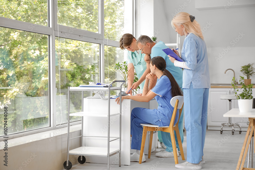 Group of doctors studying x-ray image in clinic