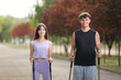 © Pixel-Shot - Sporty young couple training with walking poles outdoors