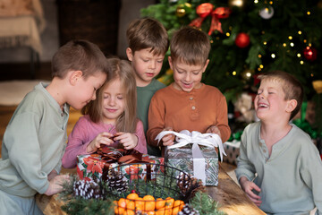 Poster - Children are opening Christmas presents under the tree