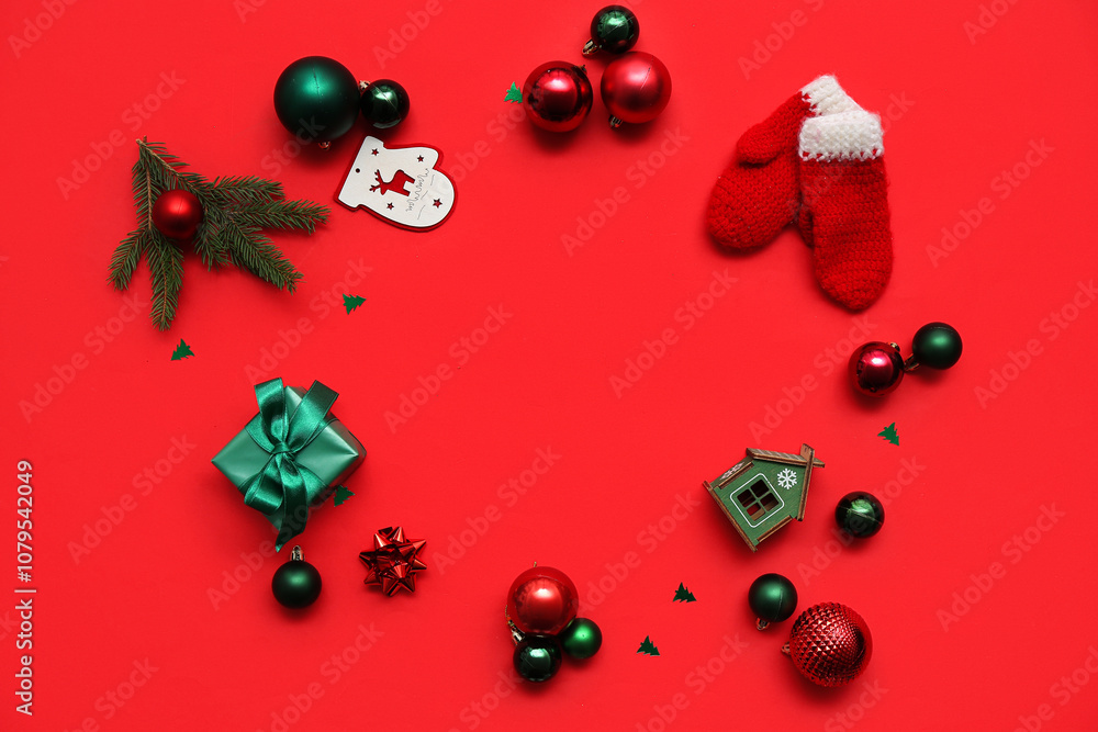 Frame made of Christmas decor, gift box and confetti on red background