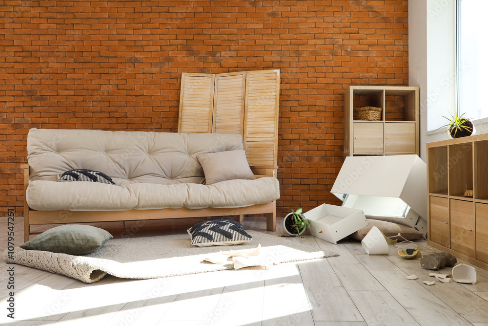 Interior of messy living room with broken things after earthquake