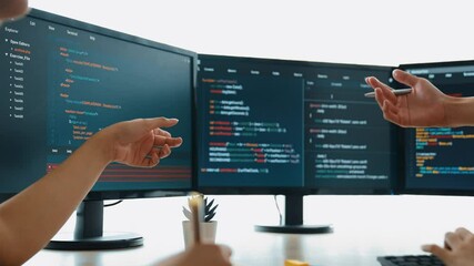 Slow motion back end software developer engineer for computer programming working together on debugging writing computing code, solving complex algorithms display on monitor in office. Burgeoning