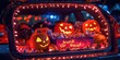 © Pech - A car trunk decorated for a Halloween 'trunk or treat' event, with lights, pumpkins, and candy for kids.