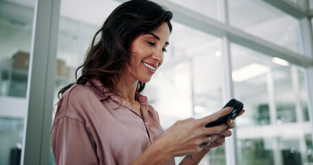 Wall Mural - Mature, business woman and happy with smartphone in office for communication, text message or positive feedback on email. Professional, person and smile with phone for notification, chat or good news