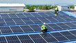 © ultramansk - engineer man inspects construction of solar cell panel or photovoltaic cell by electronic device. Industrial Renewable energy of green power. factory worker working on tower roof.