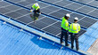 © ultramansk - Worker Technicians are working to construct solar panels system on roof. Installing solar photovoltaic panel system. Men technicians walking on roof structure to check photovoltaic solar modules.