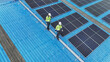 © ultramansk - Worker Technicians are working to construct solar panels system on roof. Installing solar photovoltaic panel system. Men technicians walking on roof structure to check photovoltaic solar modules.