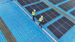 © ultramansk - Worker Technicians are working to construct solar panels system on roof. Installing solar photovoltaic panel system. Men technicians walking on roof structure to check photovoltaic solar modules.