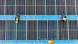 © ultramansk - Worker Technicians are working to construct solar panels system on roof. Installing solar photovoltaic panel system. Men technicians walking on roof structure to check photovoltaic solar modules.