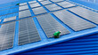 © ultramansk - top aerial of engineer men inspects construction of solar cell panel or photovoltaic cell at roof top. Industrial Renewable energy of green power. factory at urban area. worker working on tower roof.