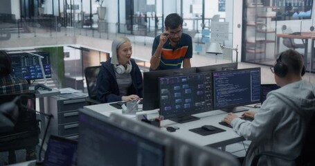 Diverse Young Colleagues Working on Computer in a Research Laboratory. Female Asking Advice from a Male Software Developer Colleague About a Solution for Their Collaborative Industrial Tech Project