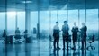 © Henhen - Professionals standing in a modern office with large windows and cityscape view.