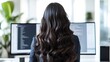 © McClerish - Woman with long curly hair sitting in front of a computer