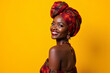© Amir Bajric - Vibrant 40s African woman in traditional attire, smiling radiantly. Portrait on solid bright yellow background. Ideal for cultural festivals, travel agencies, fair trade products