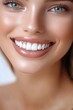 © Hryhor Denys - A young woman displays a bright, confident smile highlighting her dental implants while sitting in a well-lit dental office environment