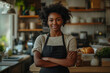 © Meekarn - A young female restaurant owner is standing in the kitchen.