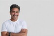 © Cristian - Smiling middle-aged spanish man with salt-and-pepper hair, wearing a casual white t-shirt, standing with arms crossed against a light gray background.