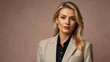 © Eightshot Images - A poised blonde businesswoman dressed in beige, exuding confidence and professionalism against a plain background.